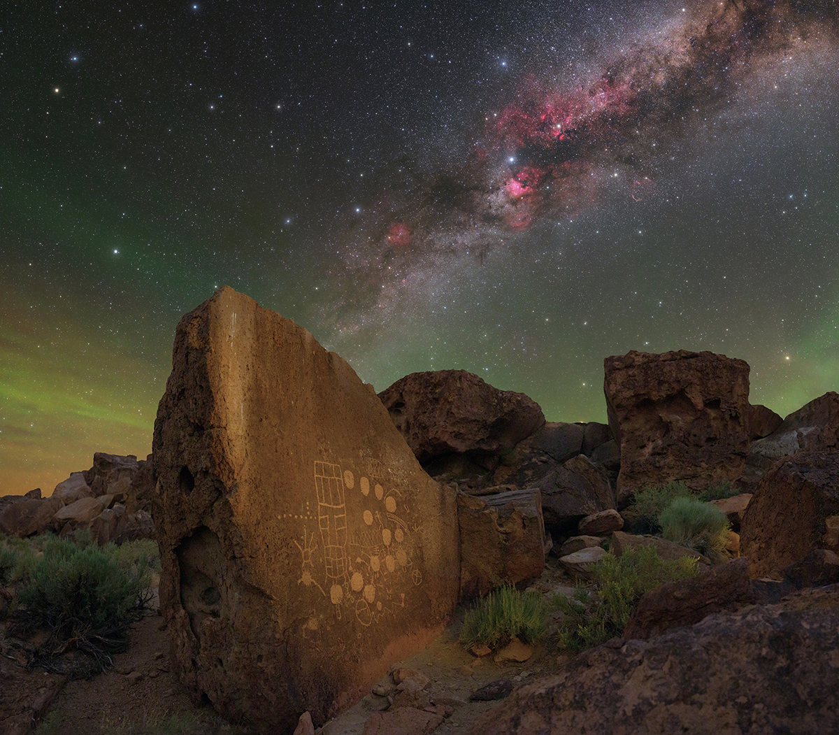 A stone with thousands of year old petroglyphs in California with the Milky Way in the sky behind A stone with thousands of year old petroglyphs in California with the Milky Way in the sky behind